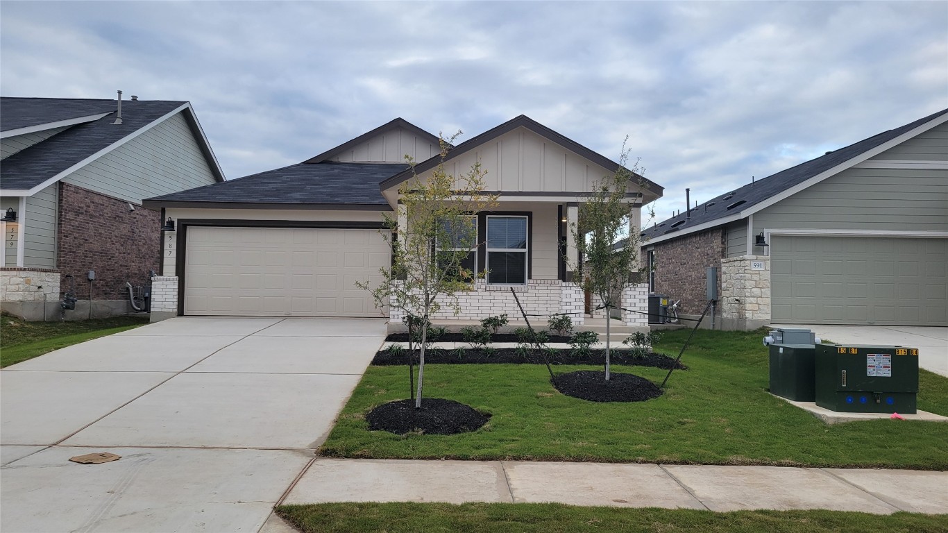 a front view of a house with a yard garage and outdoor seating