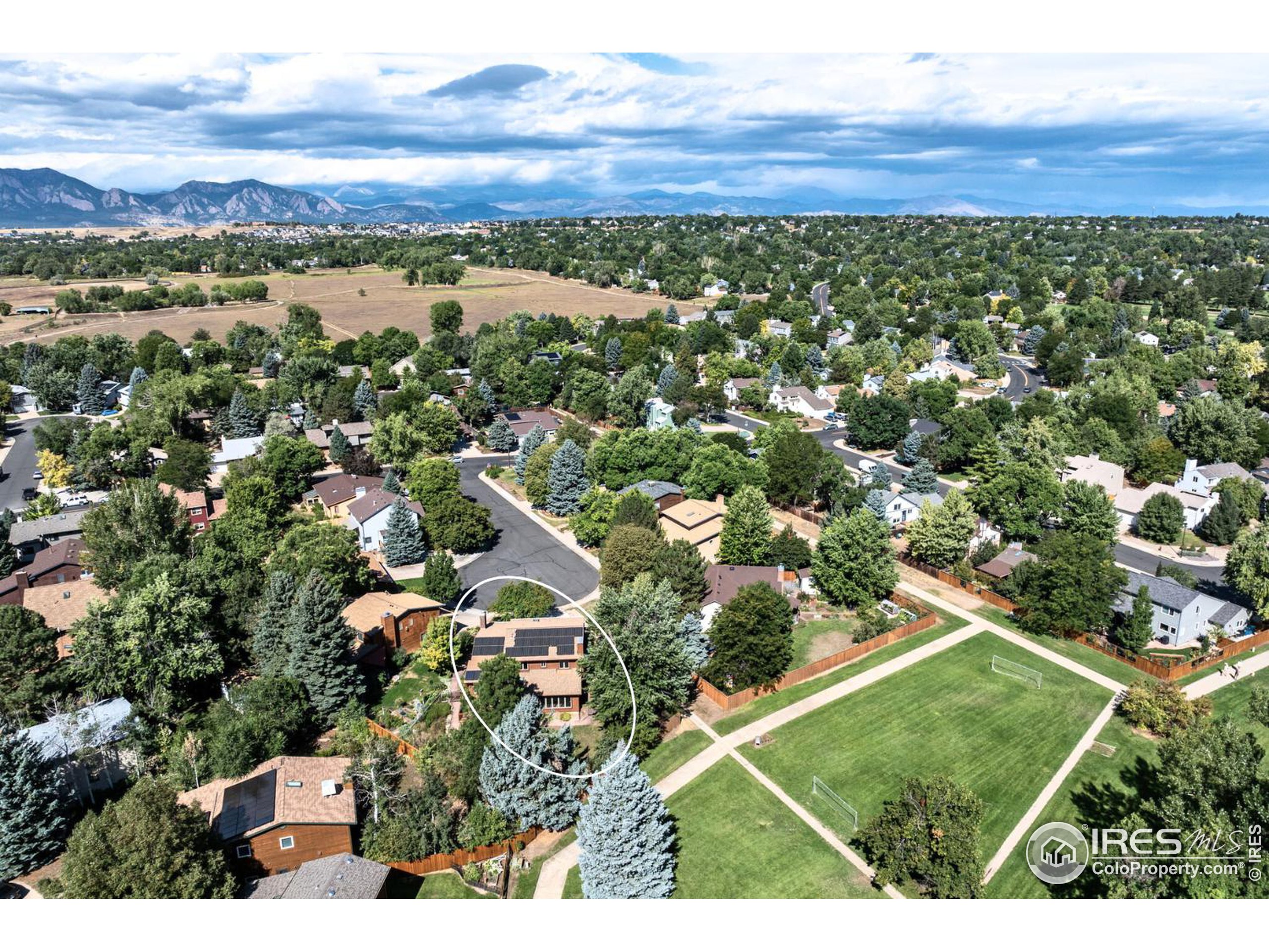 an aerial view of residential houses with outdoor space and ocean