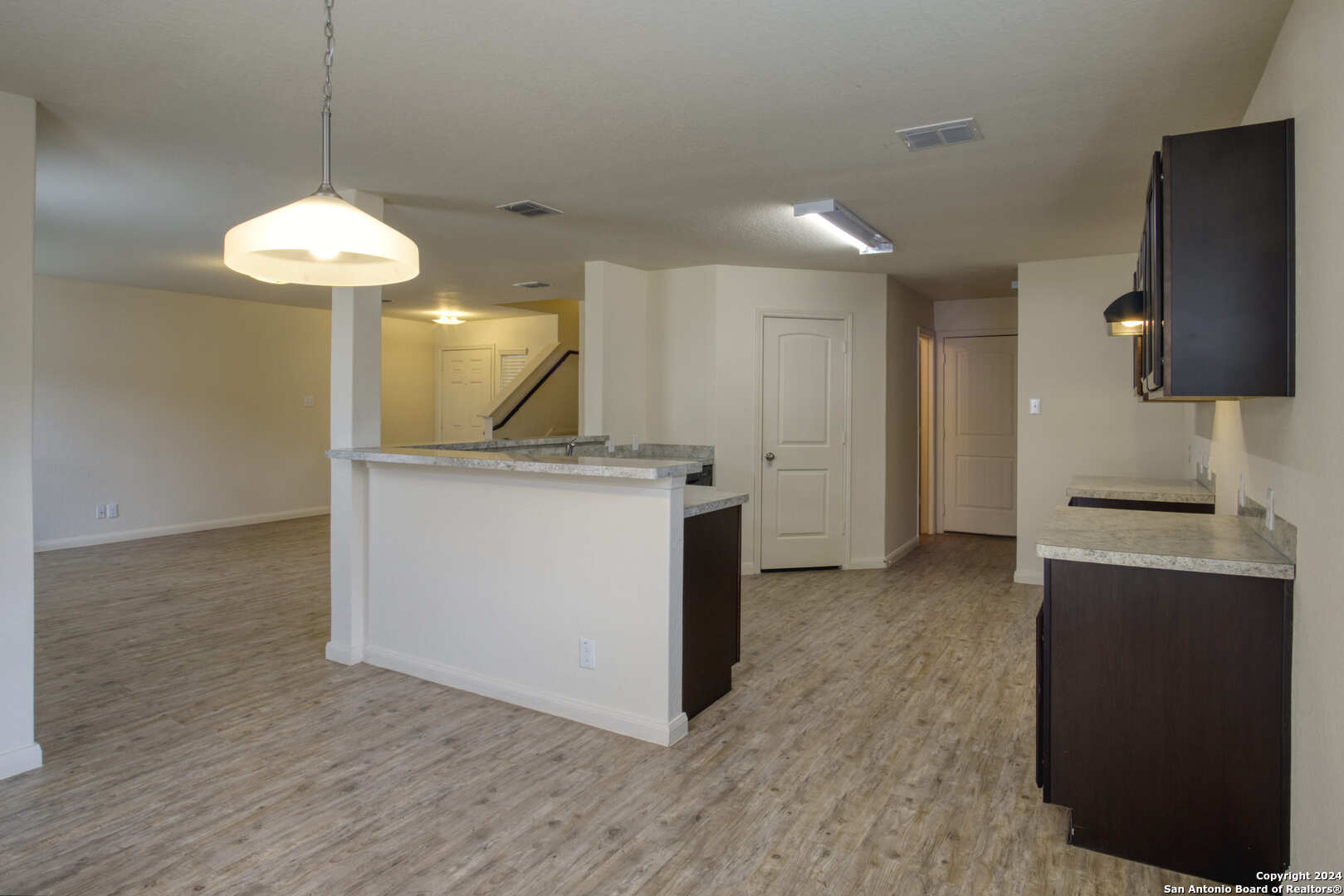 a kitchen with a stove and a chandelier