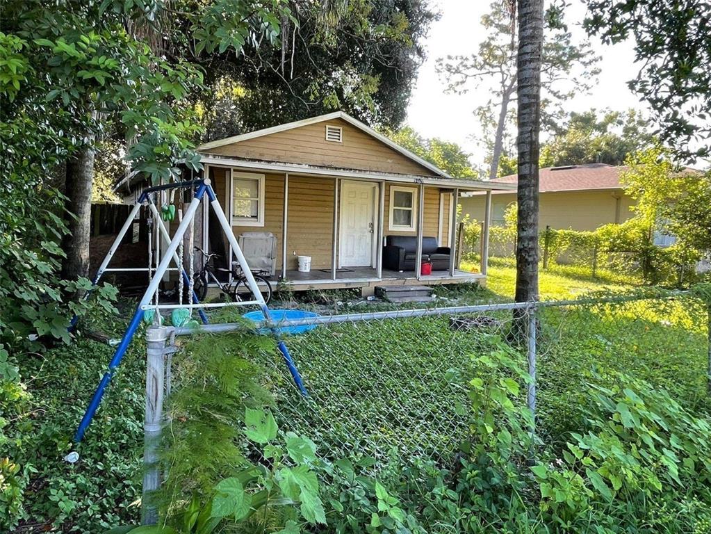 a backyard of a house with table and chairs