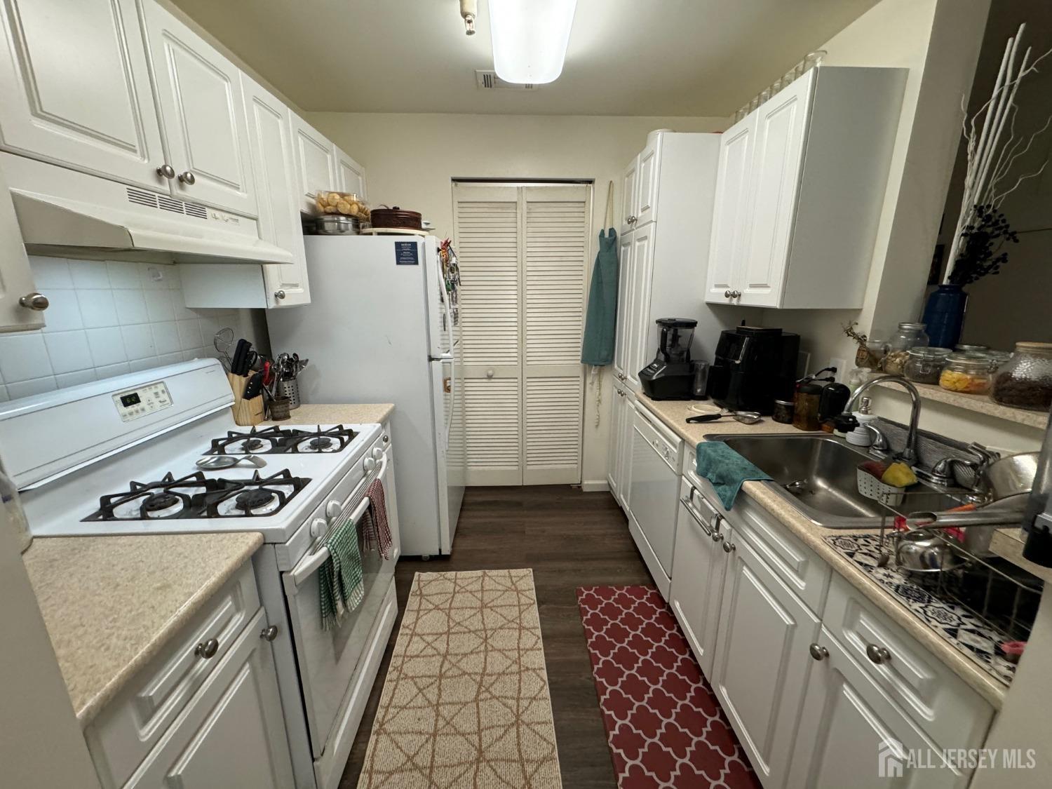 a kitchen with a stove and a refrigerator