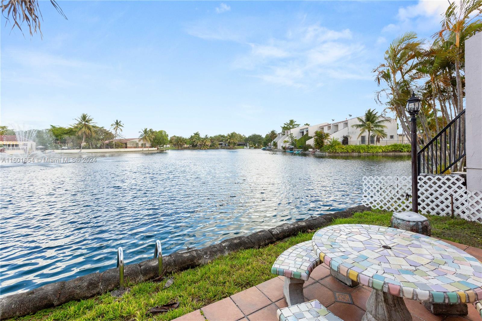 a view of a lake with houses in back