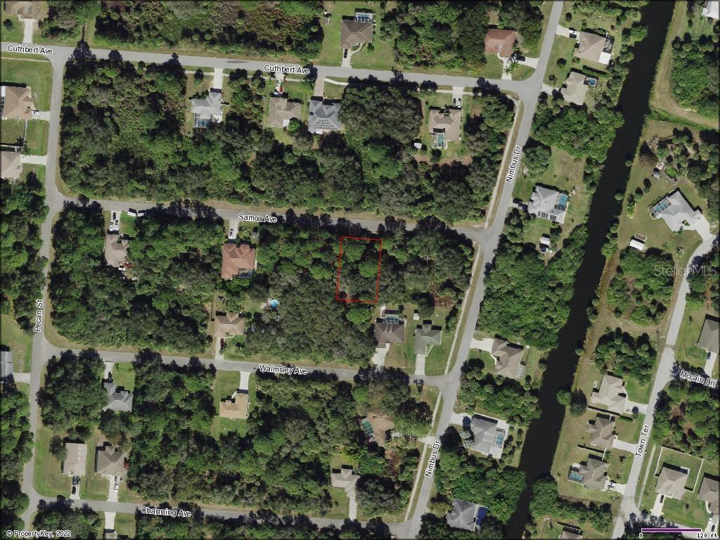 an aerial view of residential houses with outdoor space and trees