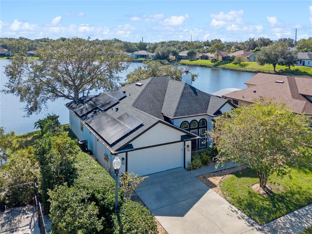 an aerial view of a house with a lake view