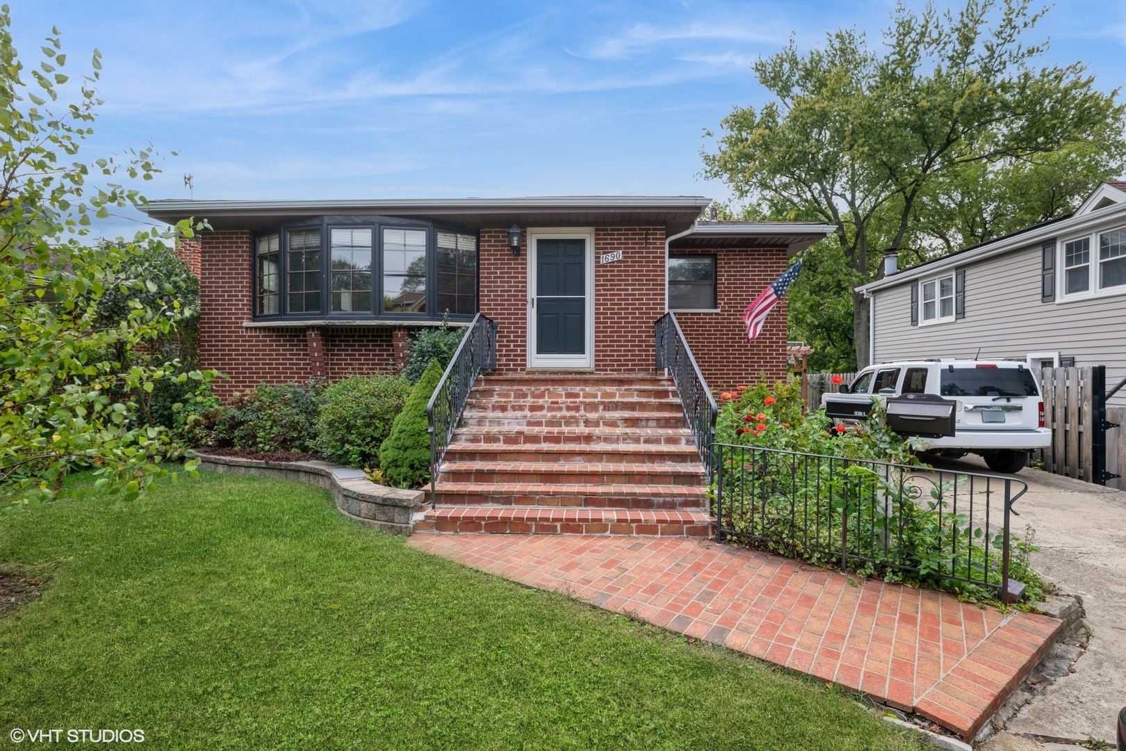 a front view of a house with a garden and patio