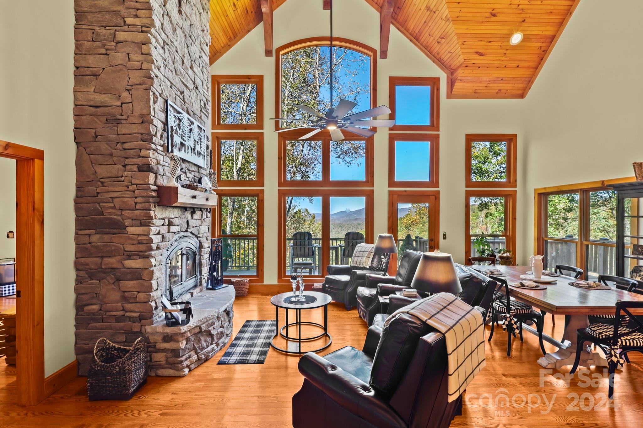 a living room with fireplace furniture and a large window