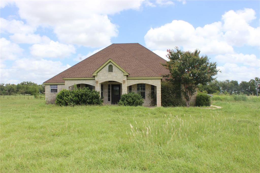 a front view of a house with a yard