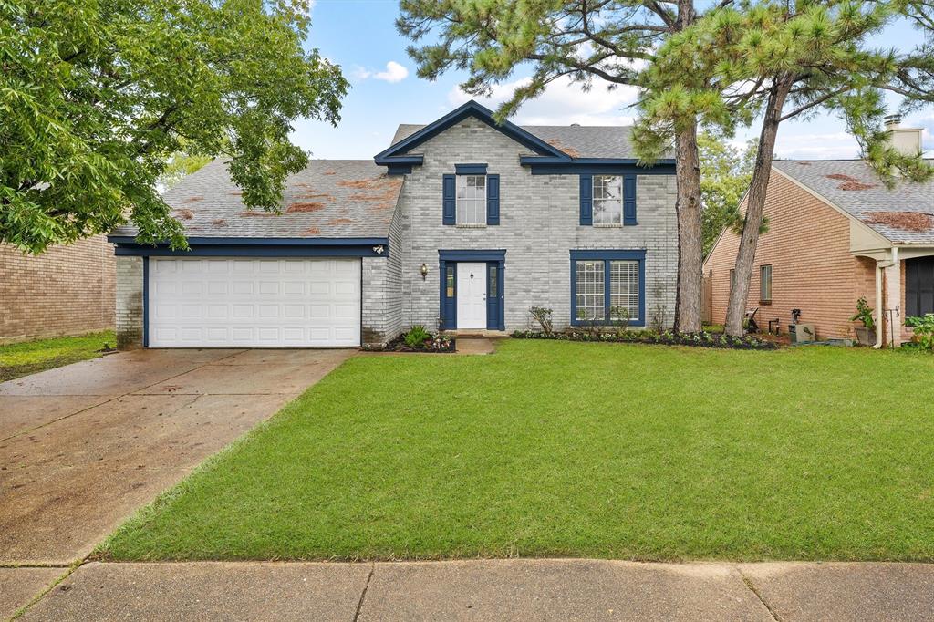 a front view of house with yard and trees