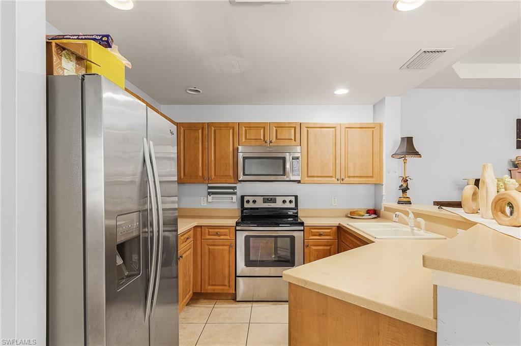 a kitchen with a sink stainless steel appliances and cabinets