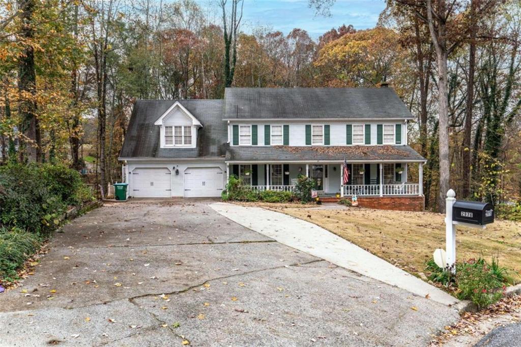 a front view of a house with yard and green space