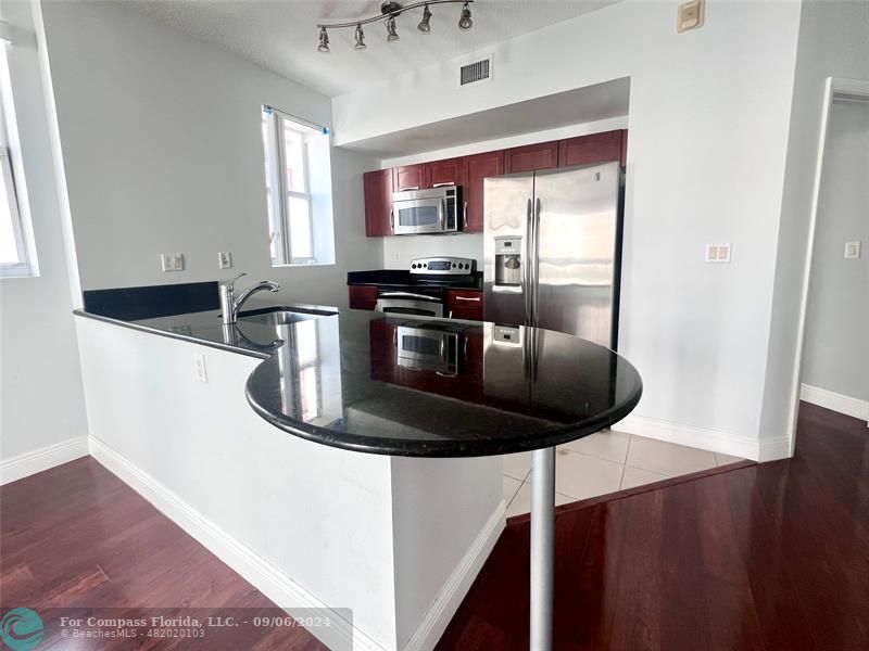 a kitchen with a stove and a refrigerator