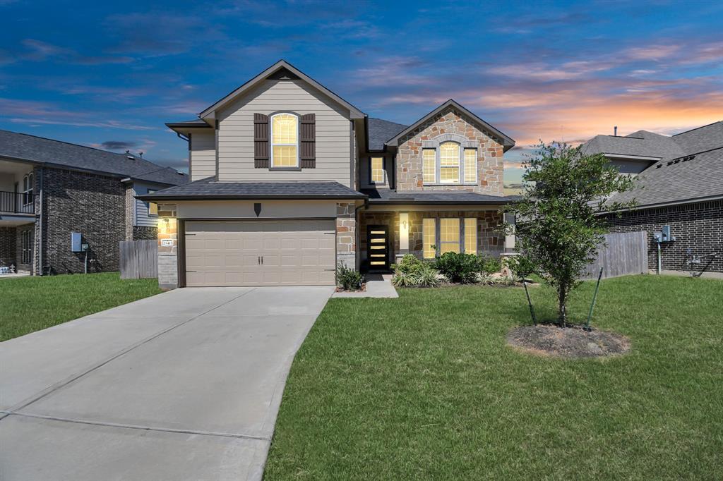 a front view of a house with a yard and garage