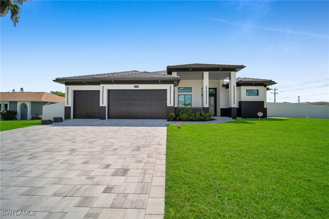 a front view of a house with a yard and garage