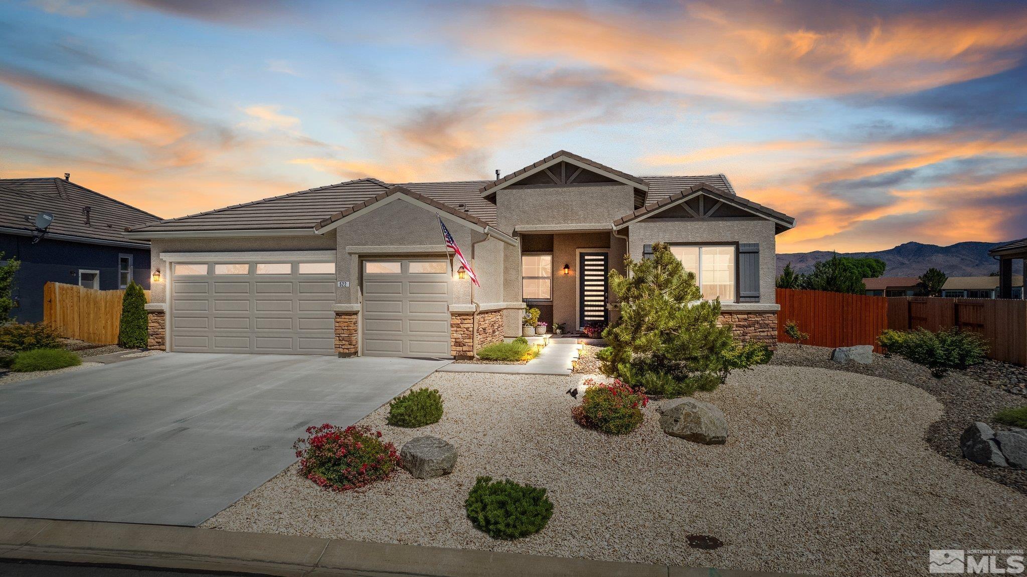 a front view of a house with a yard and a garage