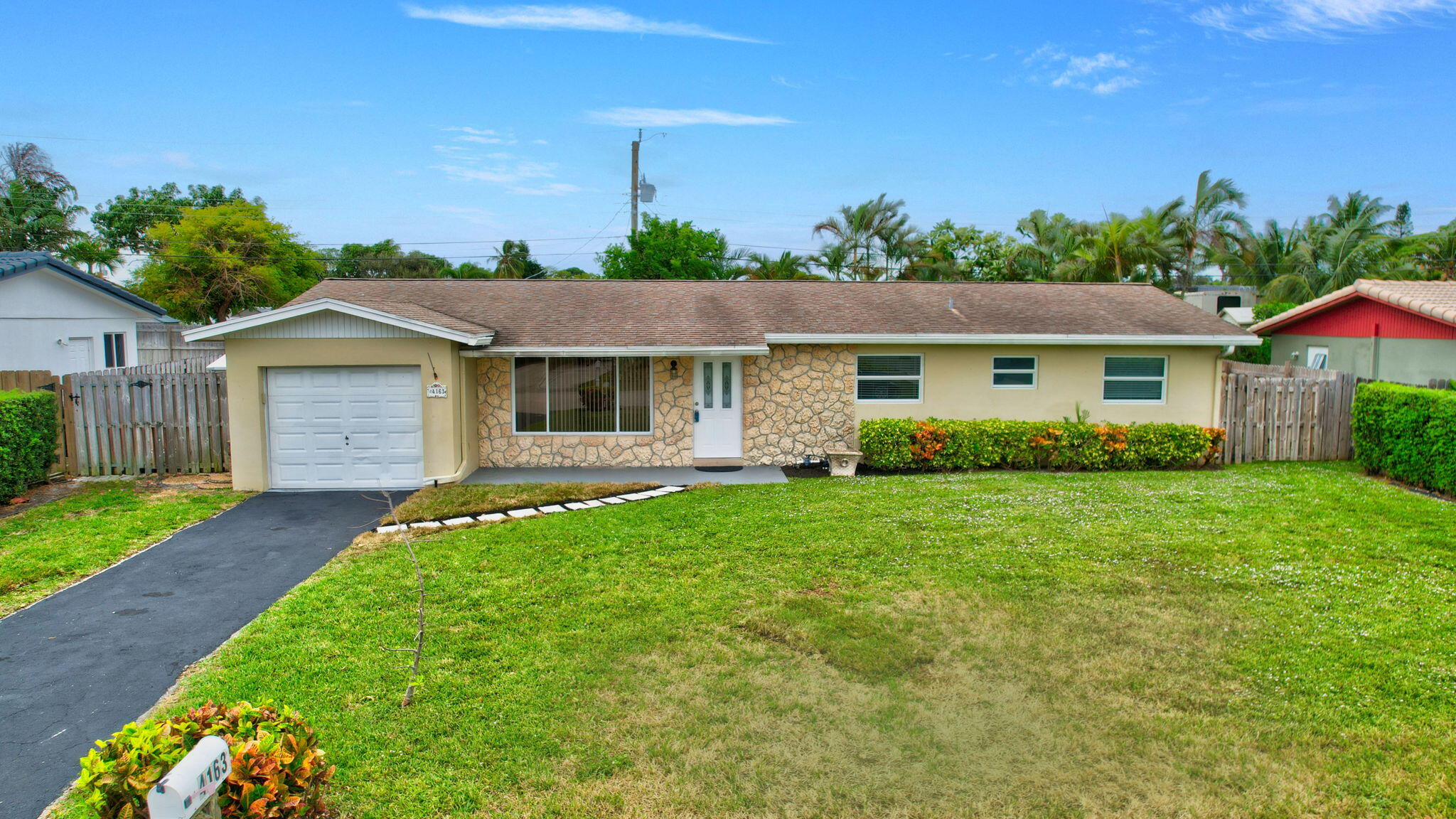 a front view of a house with a garden