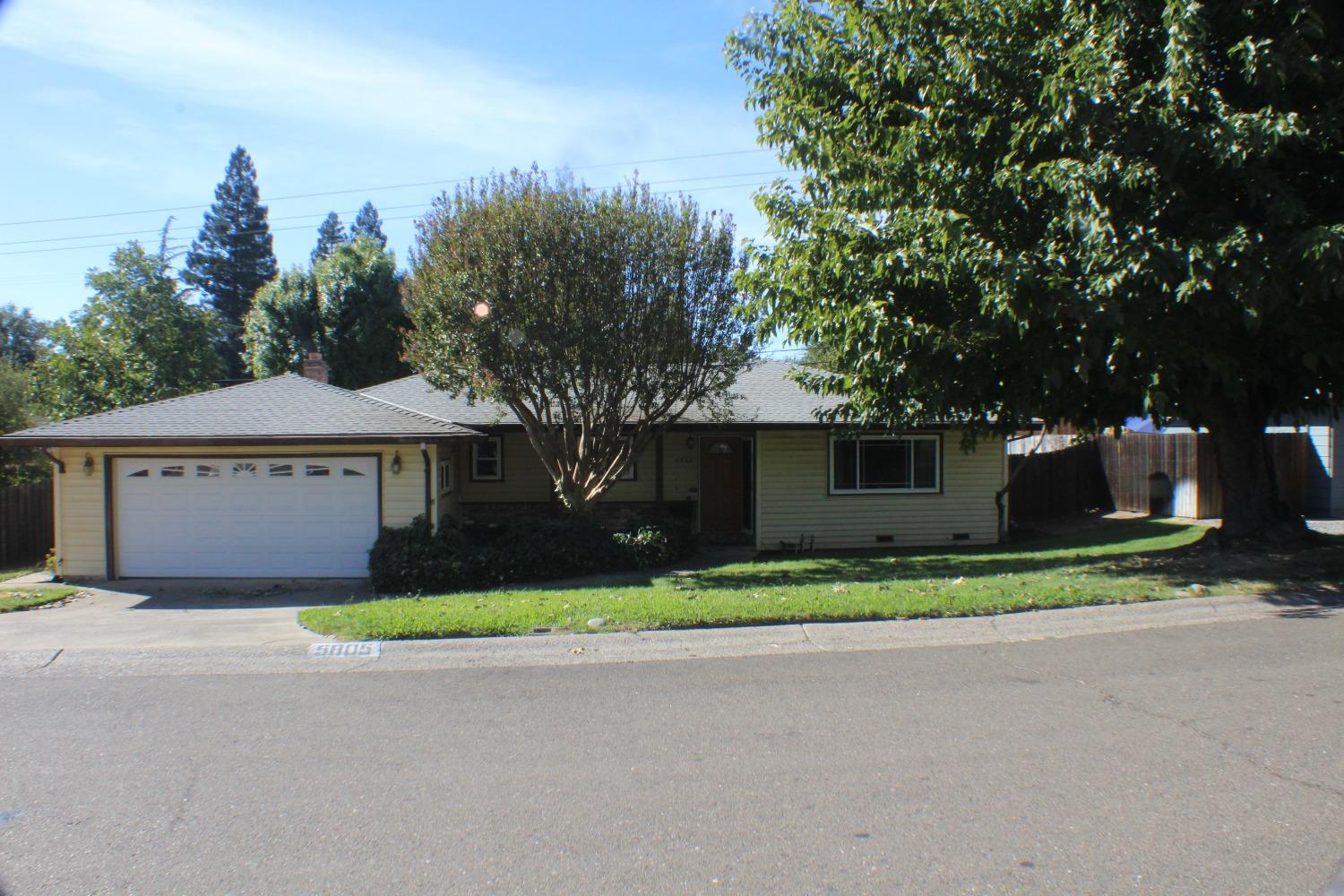 a front view of a house with a yard and a garage