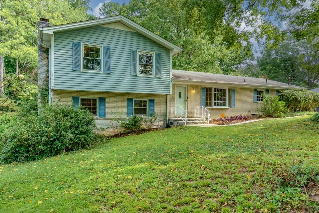 a front view of house with yard and green space