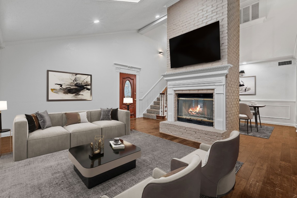 a living room with furniture a flat screen tv and a fireplace