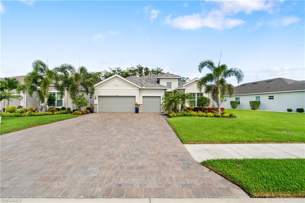 a front view of a house with a yard and garage