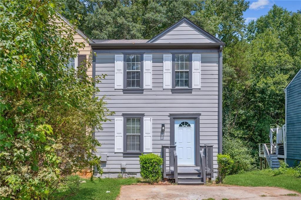 a front view of a house with garden