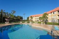 a view of swimming pool with outdoor seating and city view