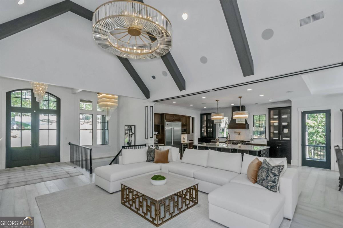 a living room with furniture wooden floor and a chandelier