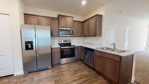 a kitchen with stainless steel appliances granite countertop a refrigerator stove and sink