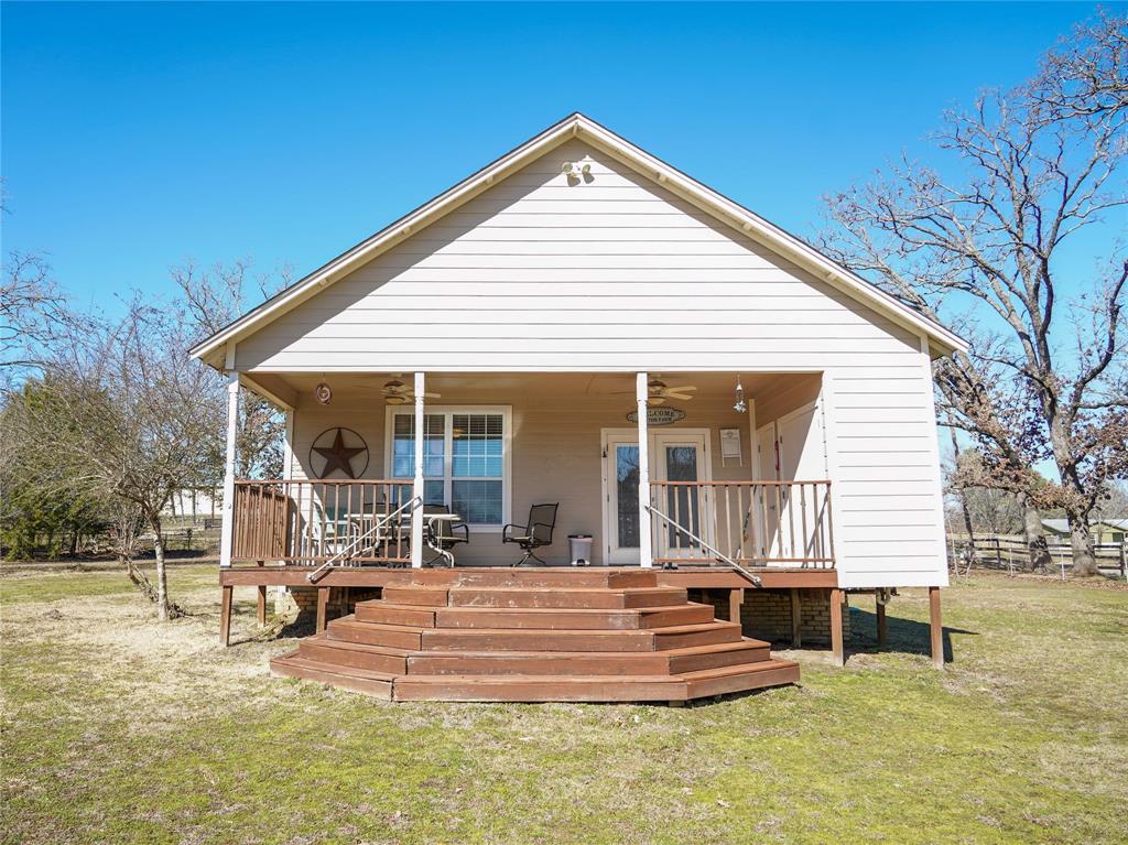 a front view of a house with a yard table and chairs