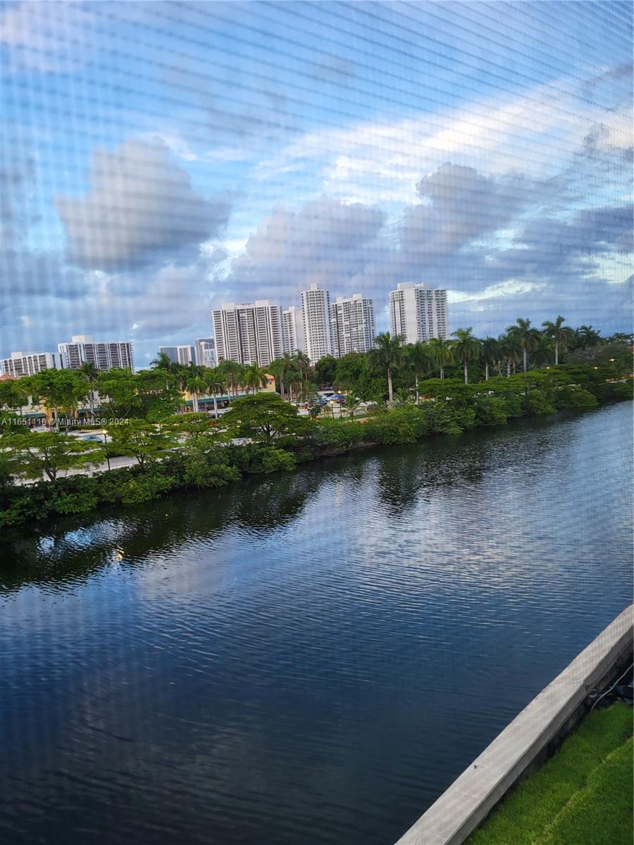 a view of a lake with houses in the back