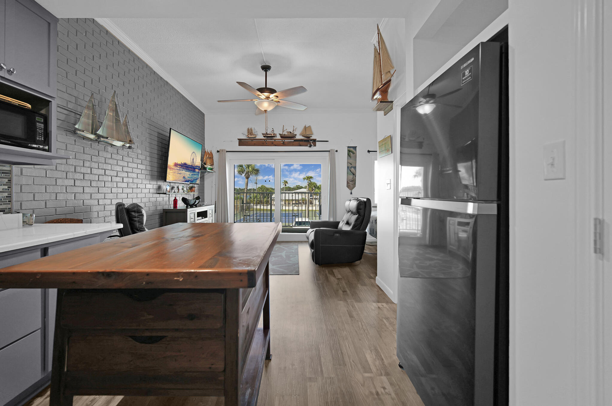 a kitchen with a table chairs refrigerator and couch