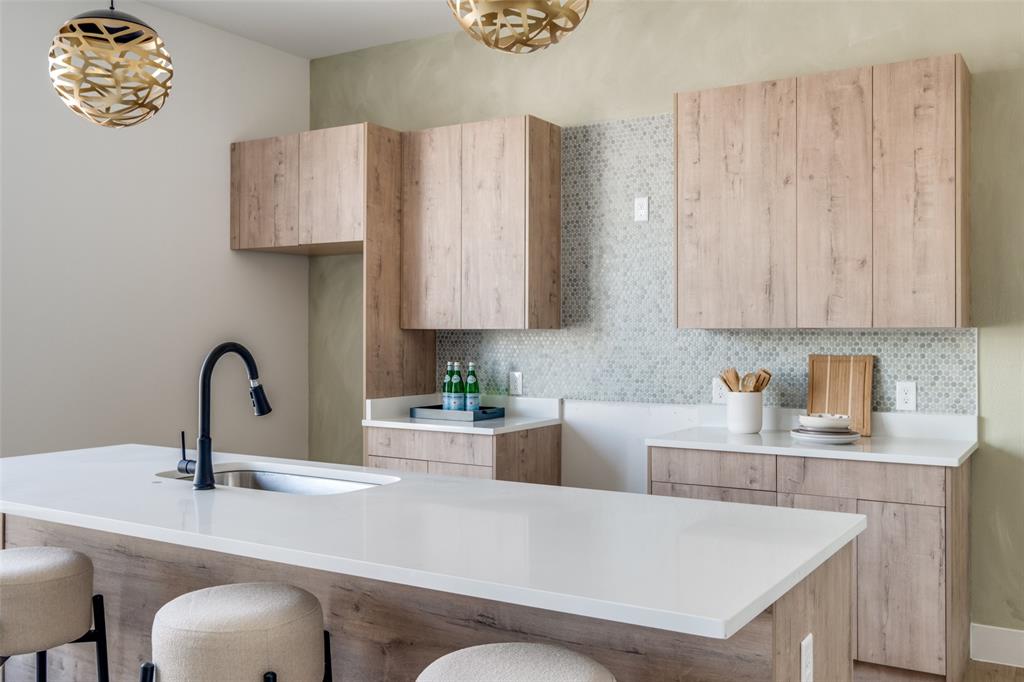 a kitchen with stainless steel appliances a sink a stove and a wooden cabinets