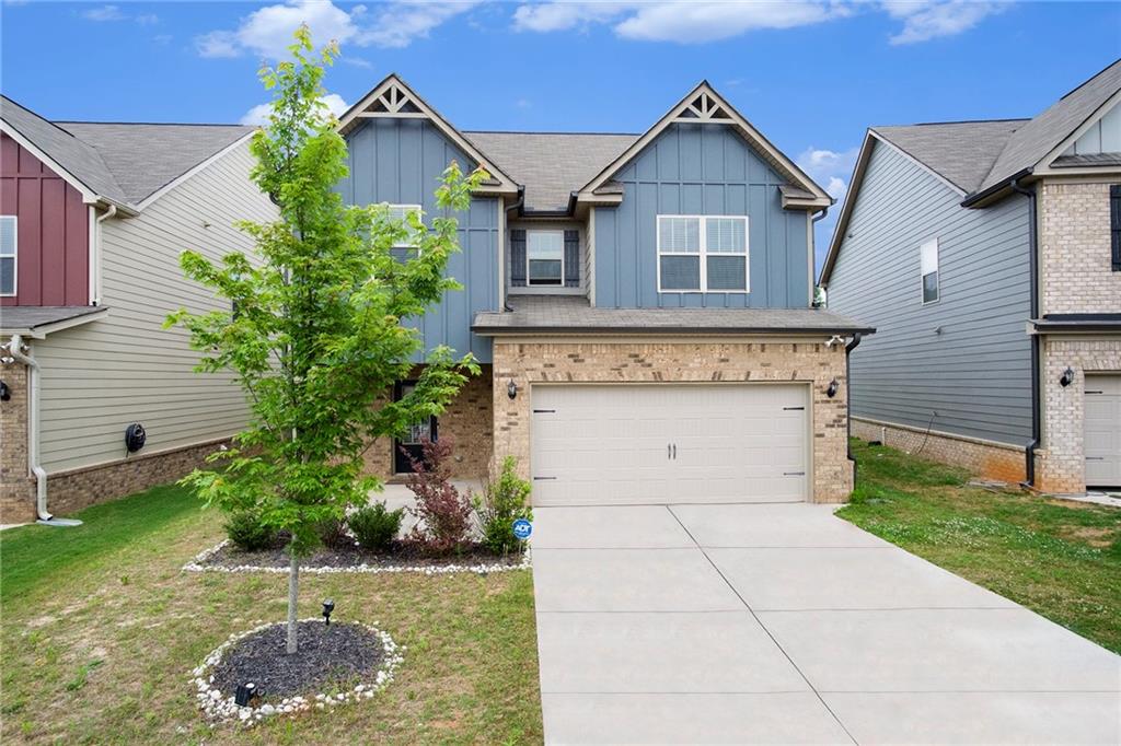 a front view of a house with a yard and garage