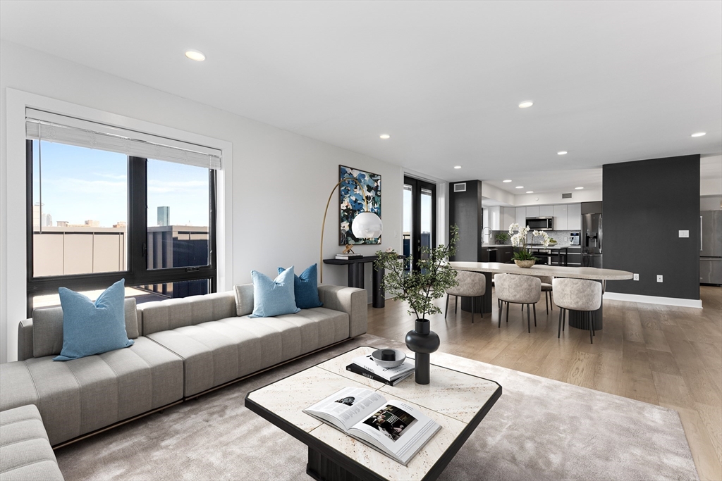 a living room with furniture and view of kitchen