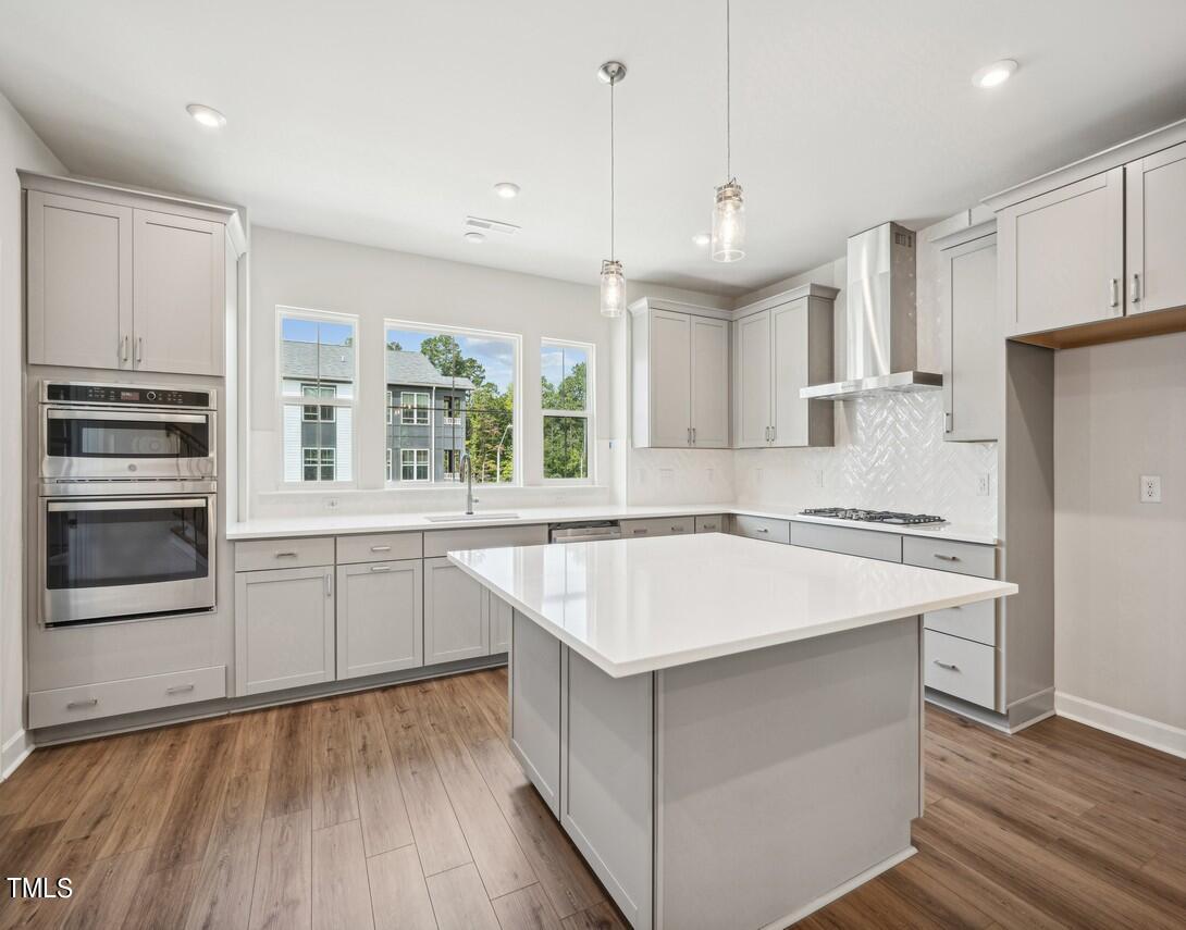 a kitchen with a sink stove and refrigerator