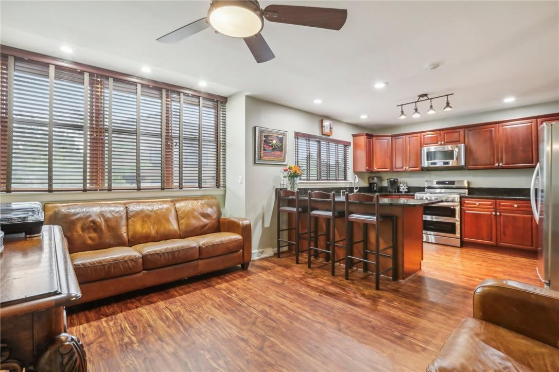 a living room kitchen with a couch and a view of kitchen