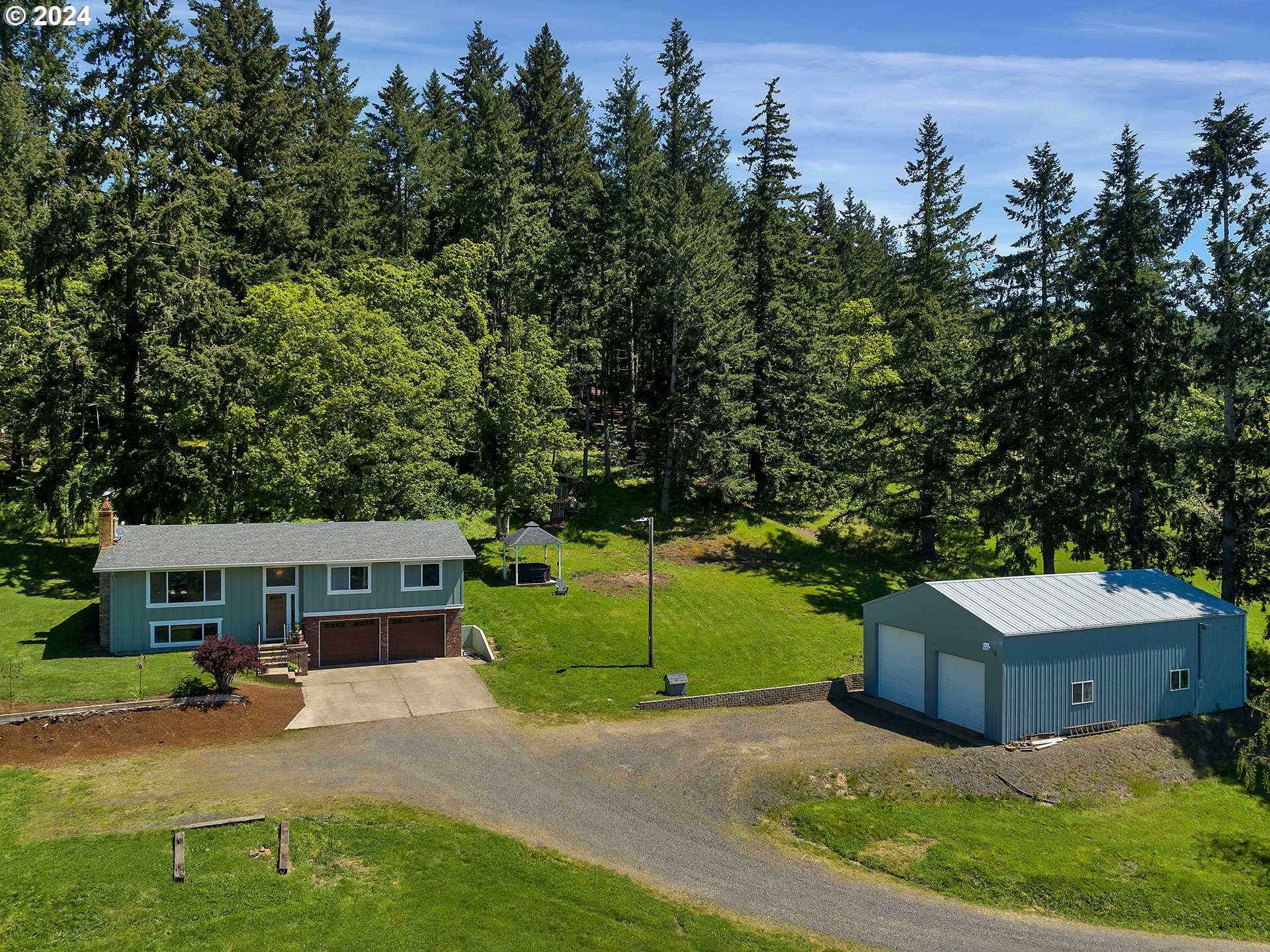 an aerial view of a house with a garden and trees