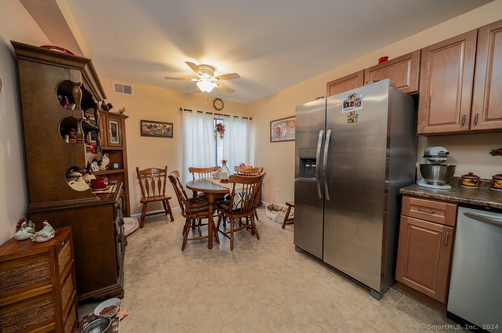 a kitchen with stainless steel appliances granite countertop a refrigerator and a stove top oven