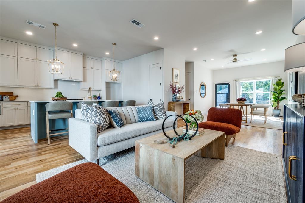 a living room with furniture a dining table and chairs