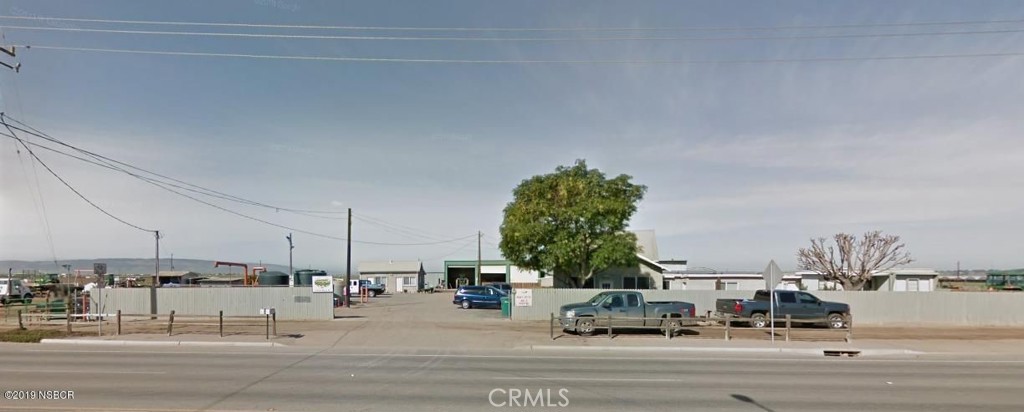 a building with trees and cars