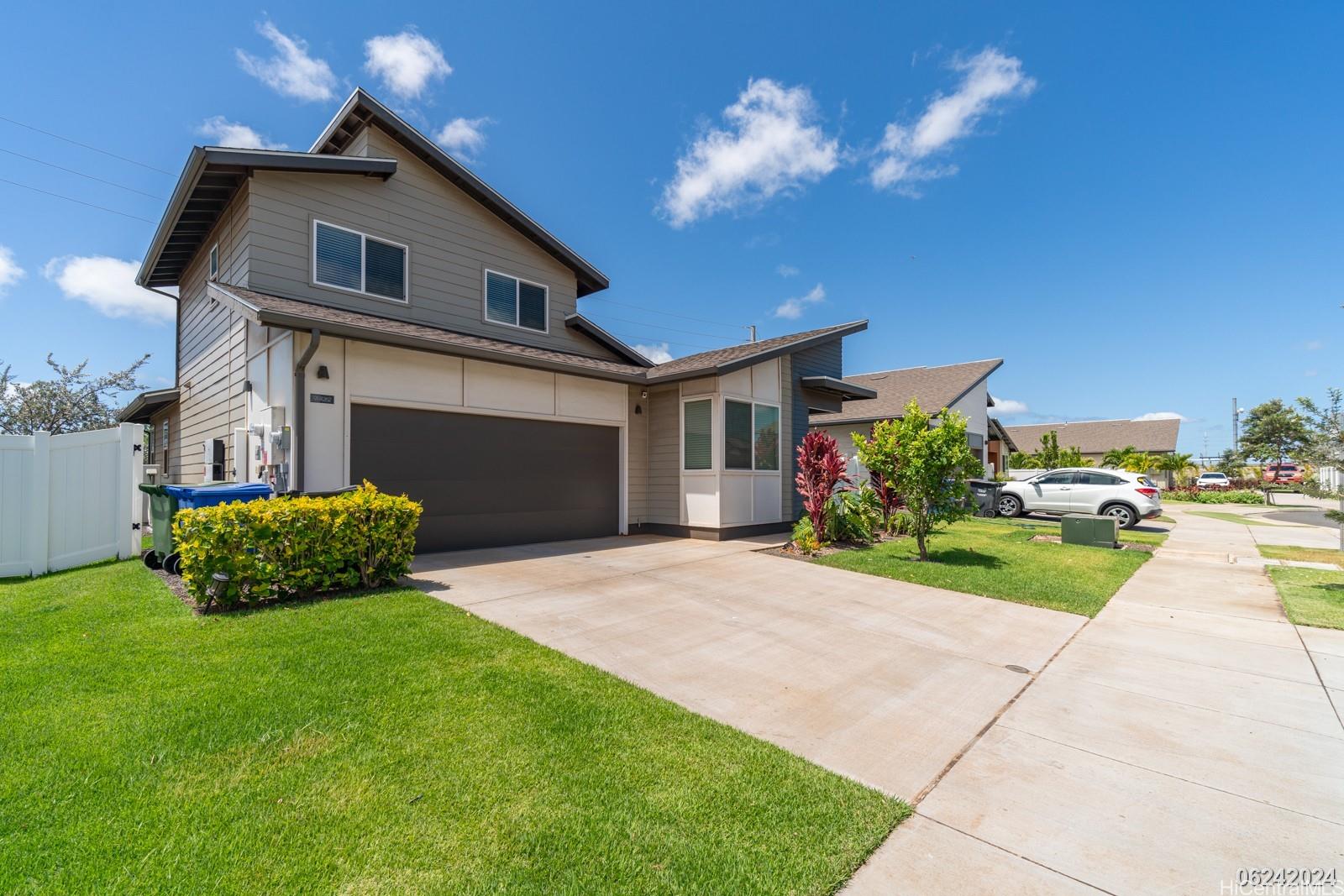 a front view of a house with a yard and garage