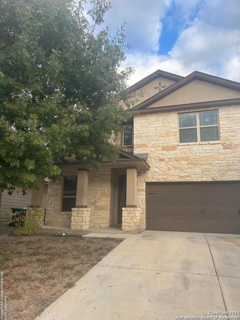 a front view of a house with garage