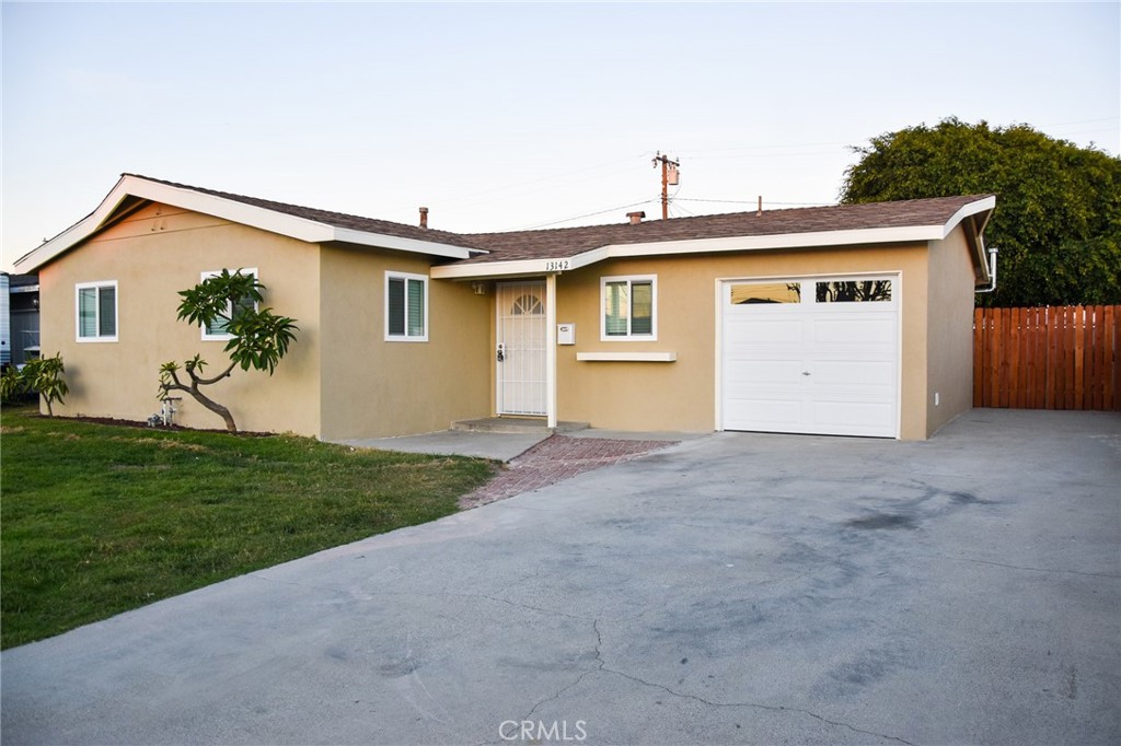 a view of a house with a yard and garage