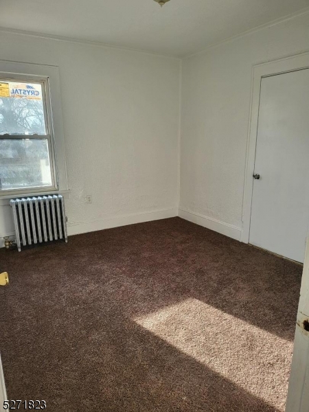 a view of a room with wooden floor and window