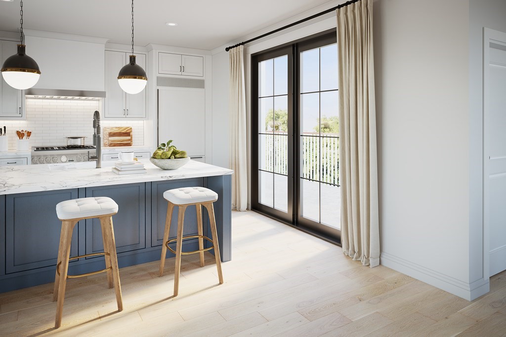 a large kitchen with a table and chairs