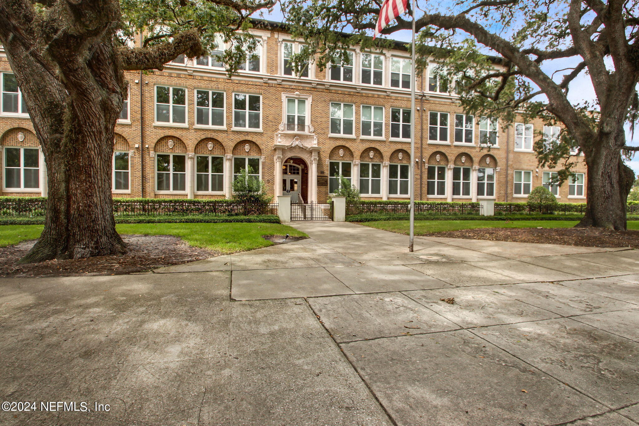 a view of a brick building next to a yard