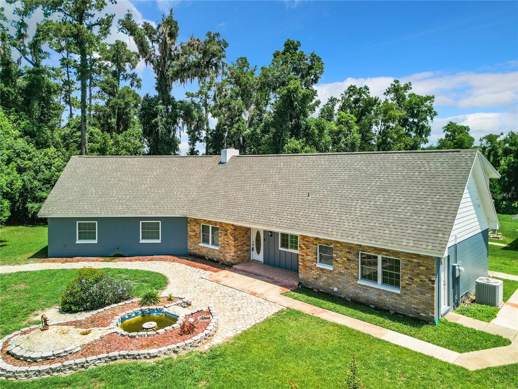 a aerial view of a house with a yard