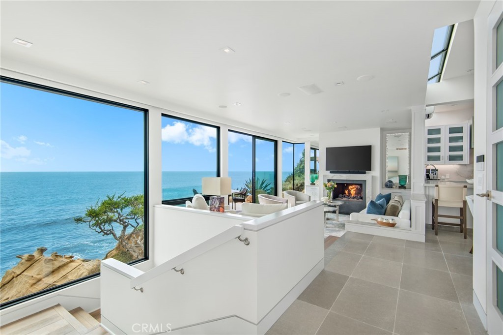 a living room with furniture a large window with kitchen view