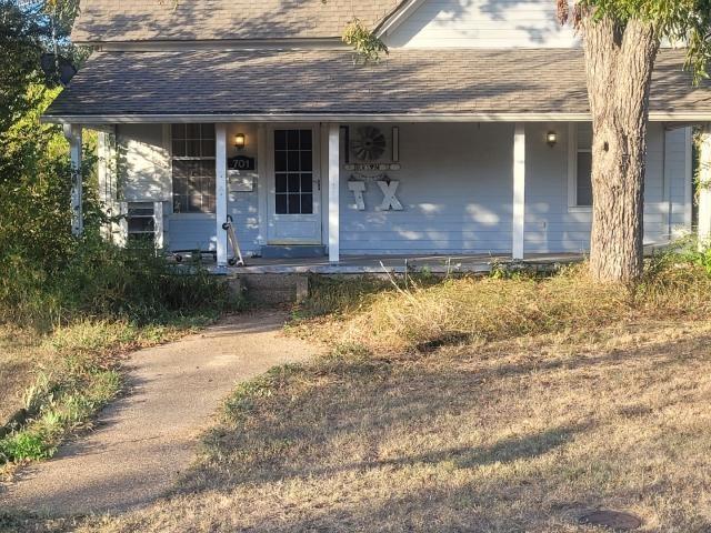 a view of a house with a yard from a fountain