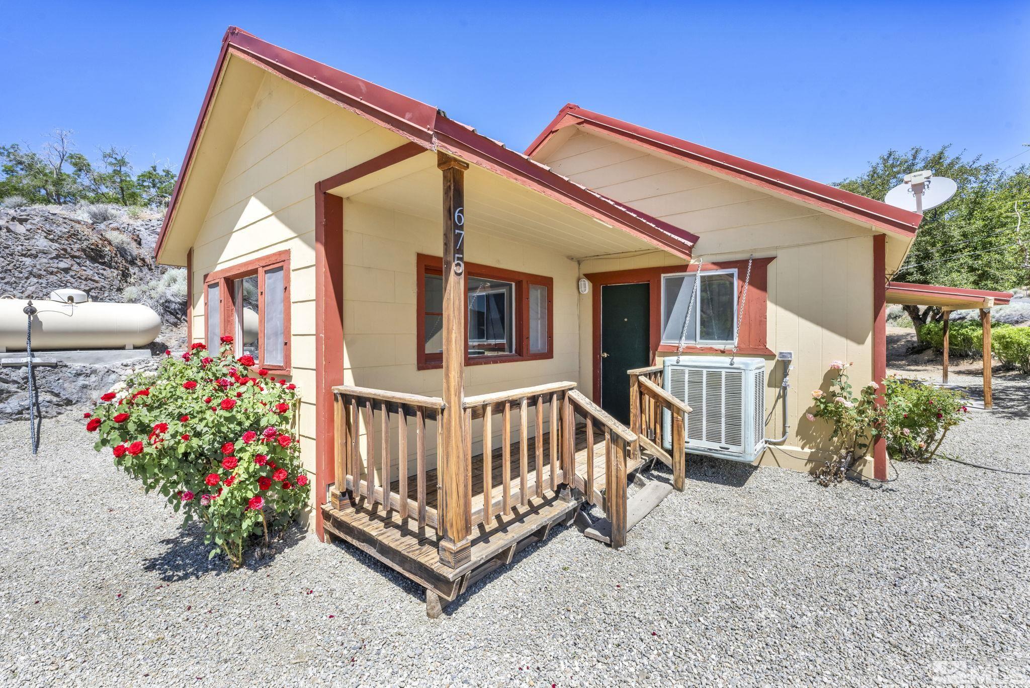 a view of backyard with a small deck and a chair