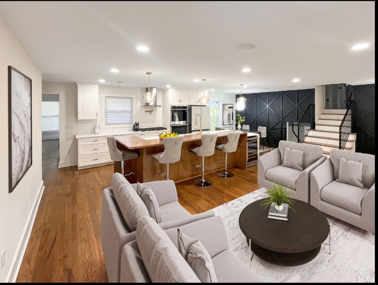 A spacious great room features a luxury kitchen featuring double ovens and a gas cooktop, a large island with bar seating, a formal dining area, and a relaxing sitting area with a picture window. *virtually staged